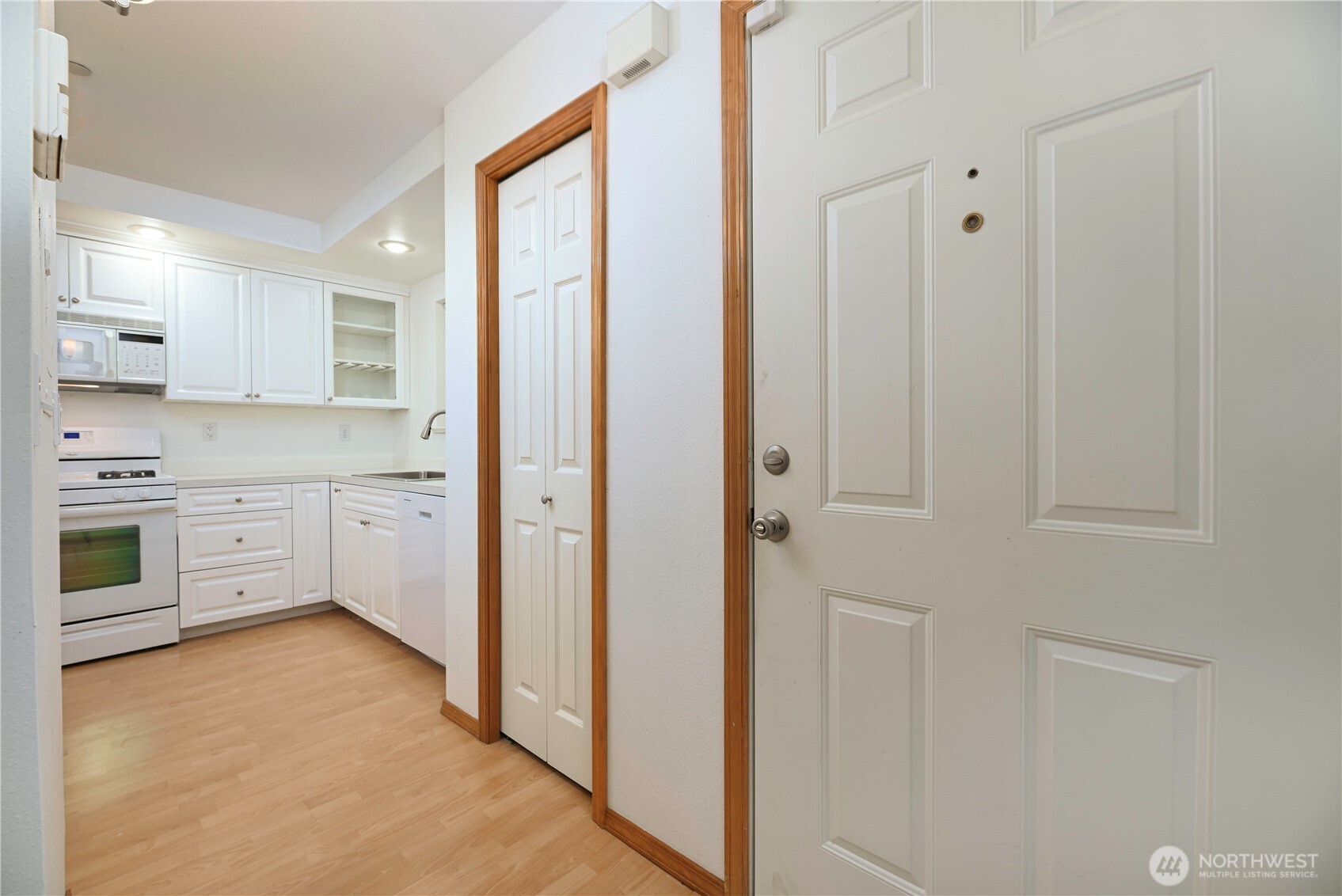 509 1st Street, Unit 104 Snohomish, WA 98290 - Photo 5 of 33 a kitchen with stainless steel appliances a stove a sink and white cabinets