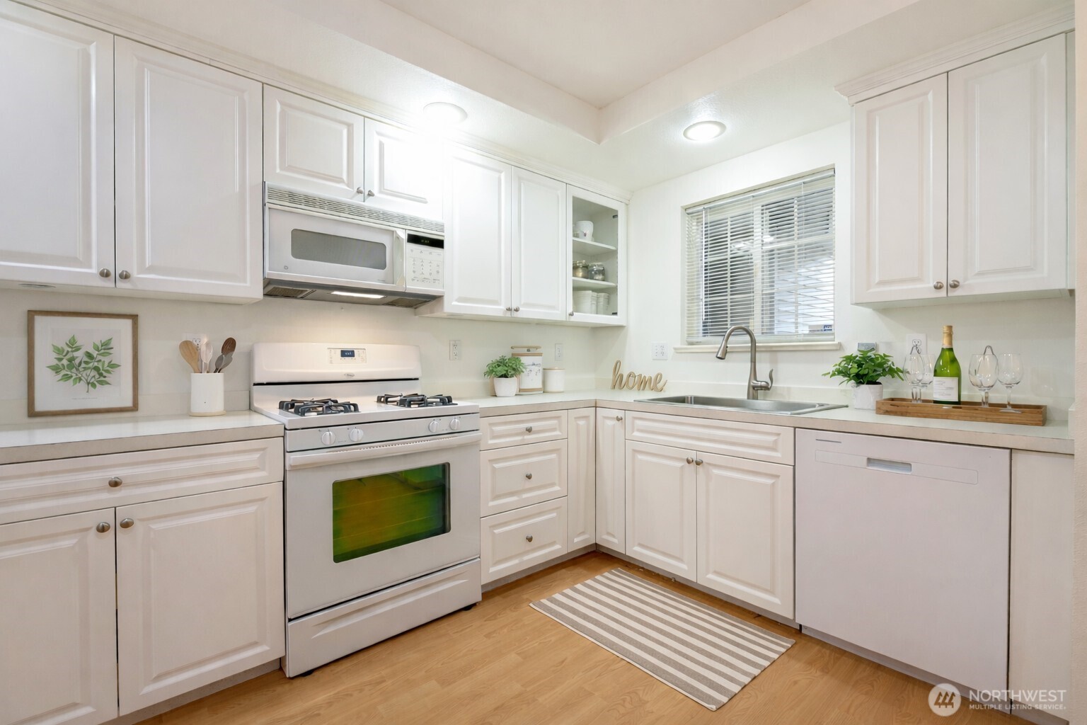 509 1st Street, Unit 104 Snohomish, WA 98290 - Photo 6 of 33 a kitchen with cabinets appliances a sink and a window