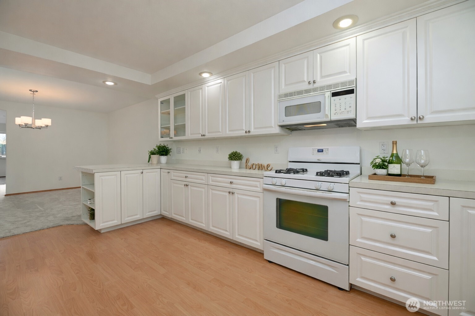 509 1st Street, Unit 104 Snohomish, WA 98290 - Photo 7 of 33 a kitchen with granite countertop white cabinets and white appliances