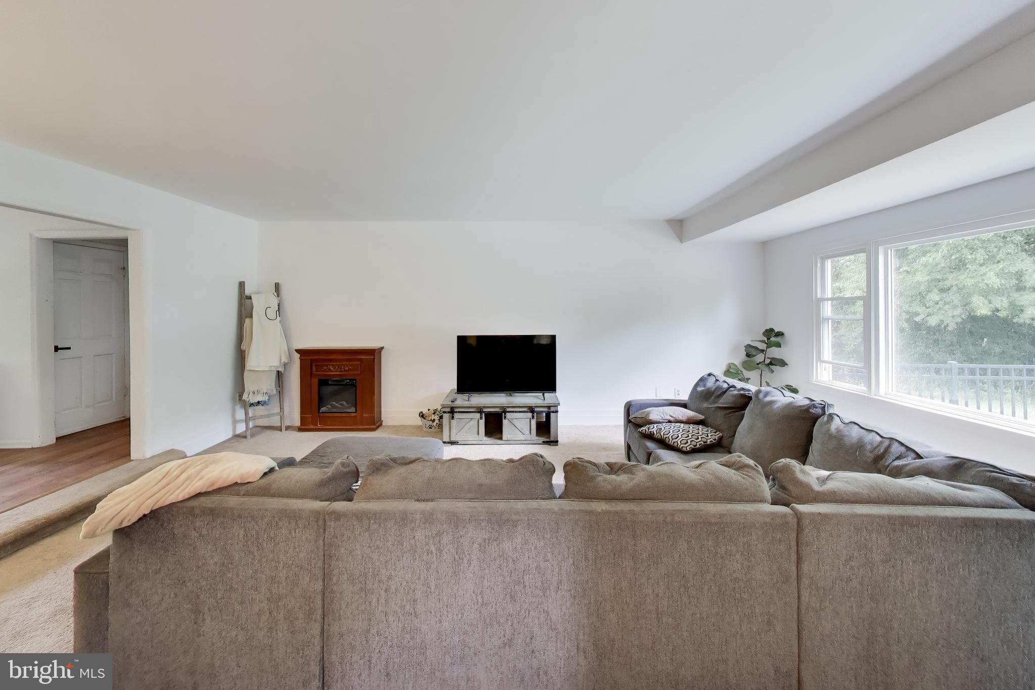 3240 Juniper Lane Huntingtown, MD 20639 - Photo 37 of 48 a living room with furniture and a flat screen tv