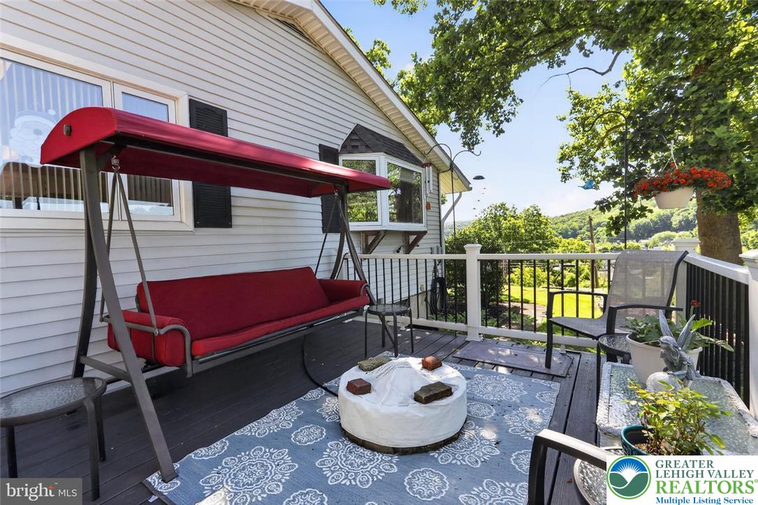 740 Public Road Bethlehem, PA 18015 - Photo 5 of 40 A welcoming patio with ample seating overlooks a scenic, tree-lined landscape.