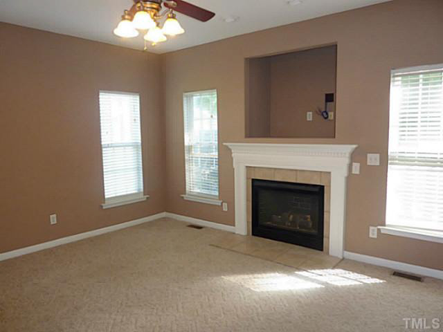 3324 Forest Mill Circle Raleigh, NC 27616 - Photo 10 of 25 Family Room has windows to the side and rear of the home. Bright and spacious, this is an inviting, warm space to relax. Gas fireplace and entertainment nook keeps things tidy and creates a clear focal point.