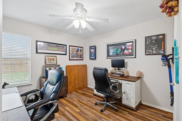 a view of a workspace with furniture and a window