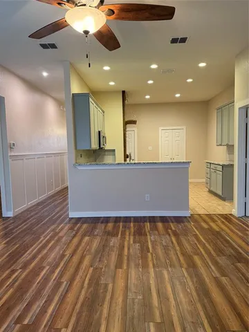 a view of a livingroom with kitchen and a sink