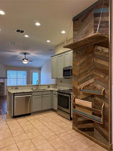 a kitchen with stainless steel appliances granite countertop a stove and a sink