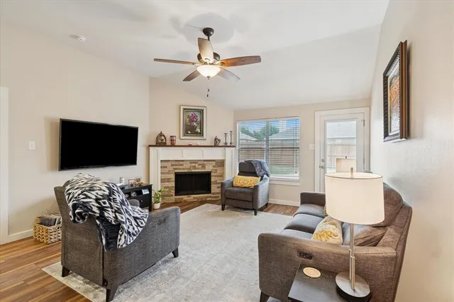a living room with furniture a fireplace and a flat screen tv