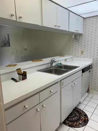 a kitchen with a sink and cabinets