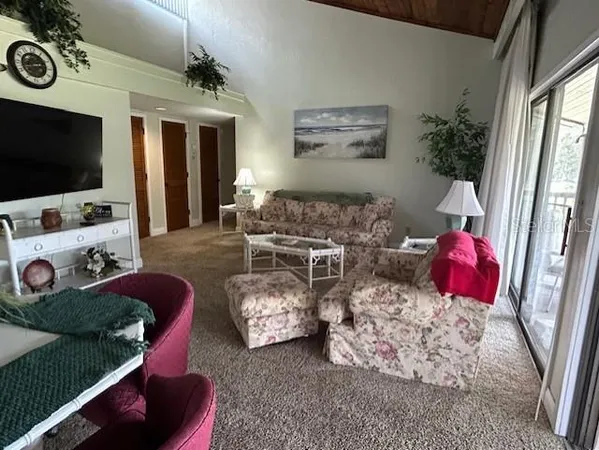 a bedroom with a bed a mirror on dresser and a window