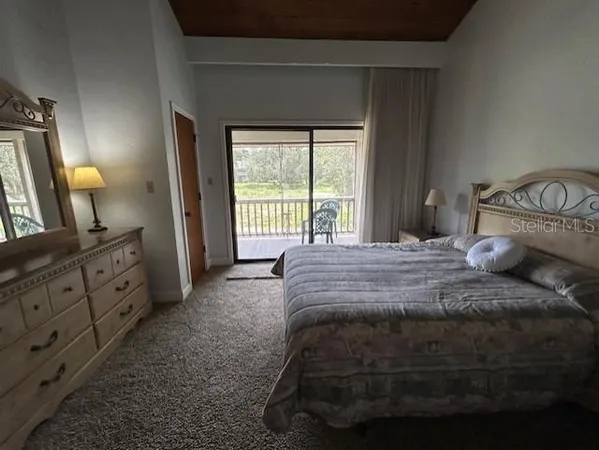 a bedroom with bed couch and window