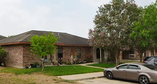 a car parked in front of a house with a yard