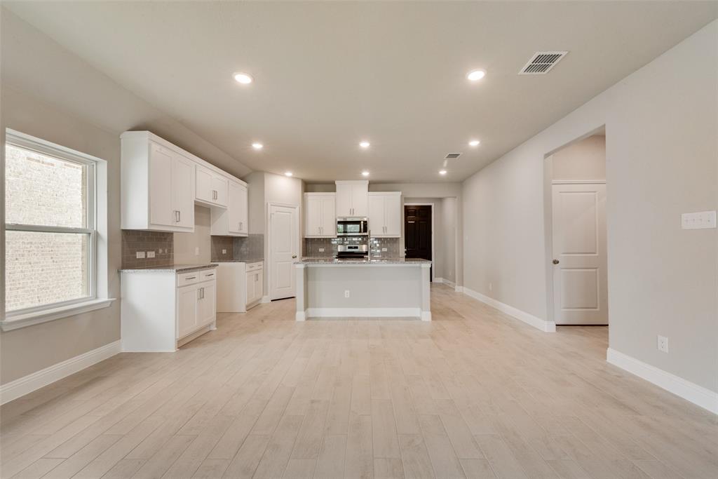 3206 Ferrero Lane Princeton, TX 75407 - Photo 13 of 29 a view of kitchen with kitchen island white cabinets and refrigerator