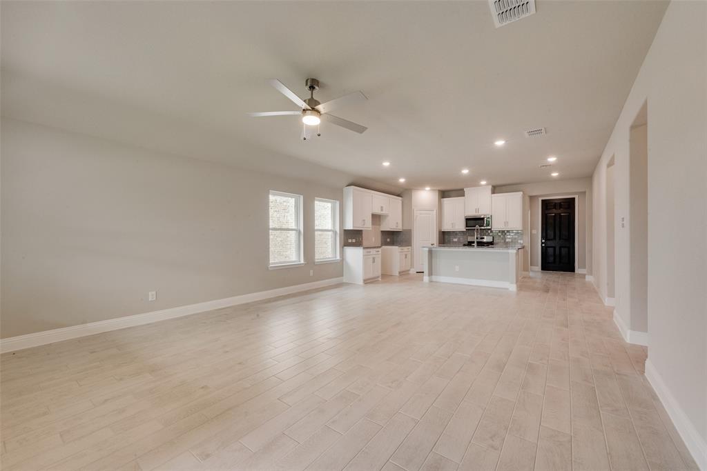 3206 Ferrero Lane Princeton, TX 75407 - Photo 14 of 29 a view of an empty room with kitchen view and a window