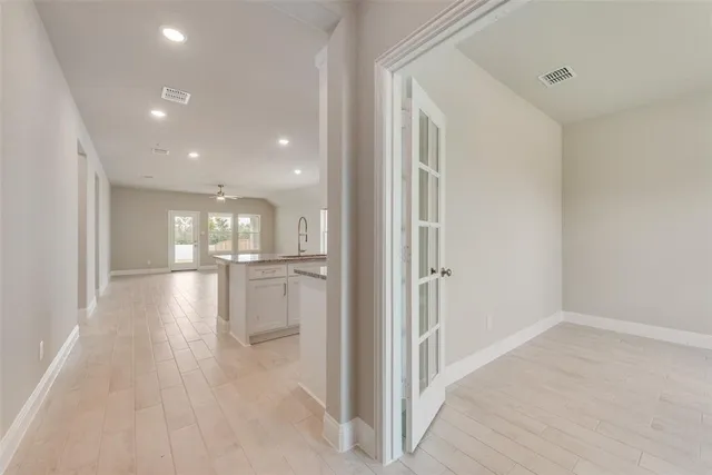 a view of a hallway with wooden floor
