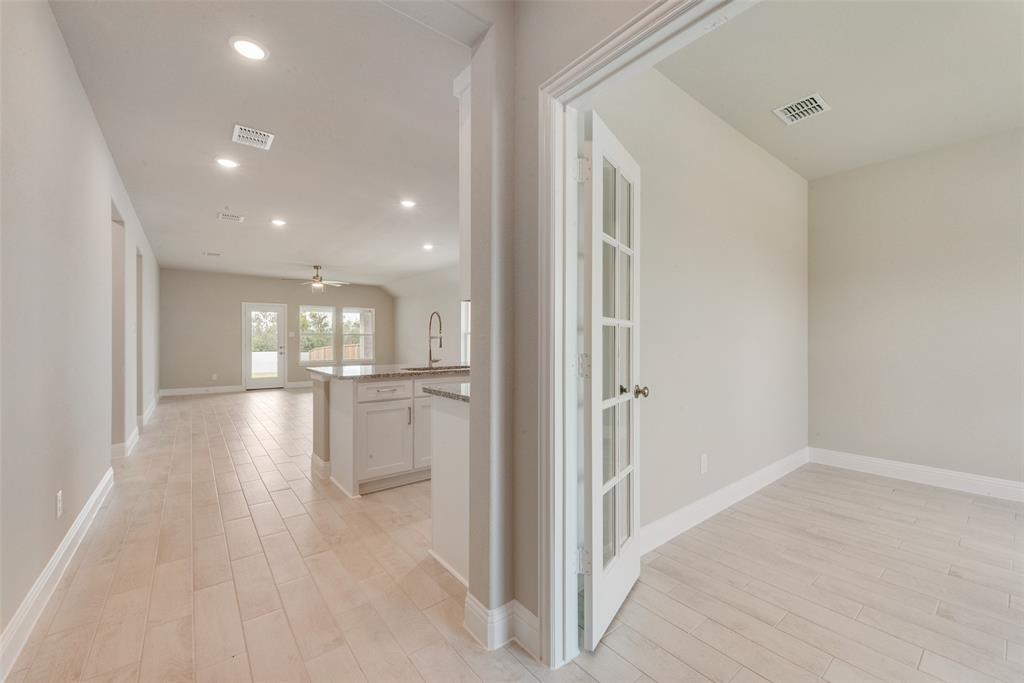 3206 Ferrero Lane Princeton, TX 75407 - Photo 5 of 29 a view of a hallway with wooden floor