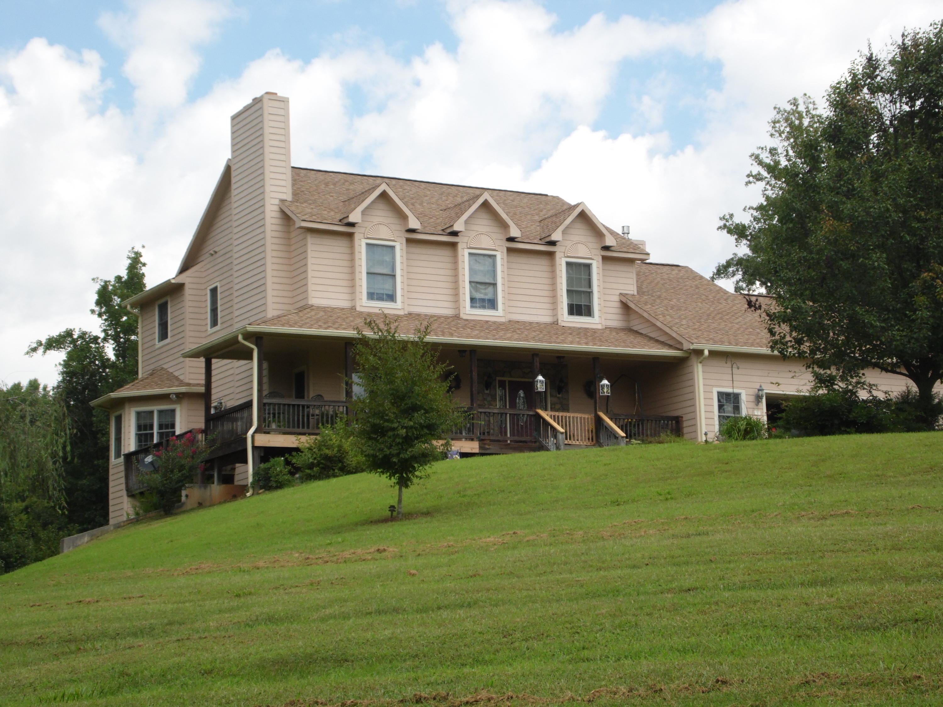 a view of a house with a yard and sitting area