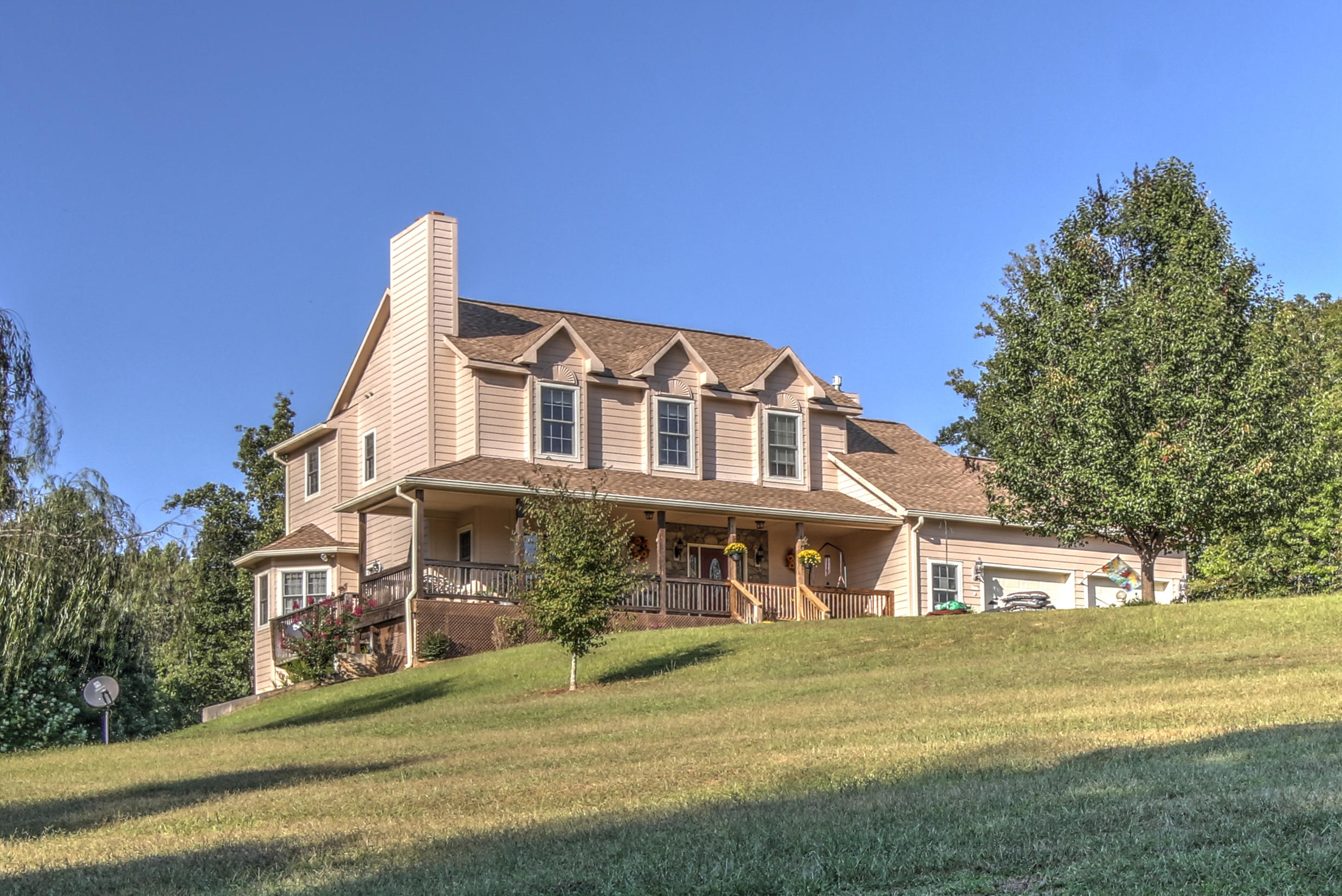 4020 Hatchett Road Penhook, VA 24137 - Photo 2 of 64 a front view of a house with a garden and lake view
