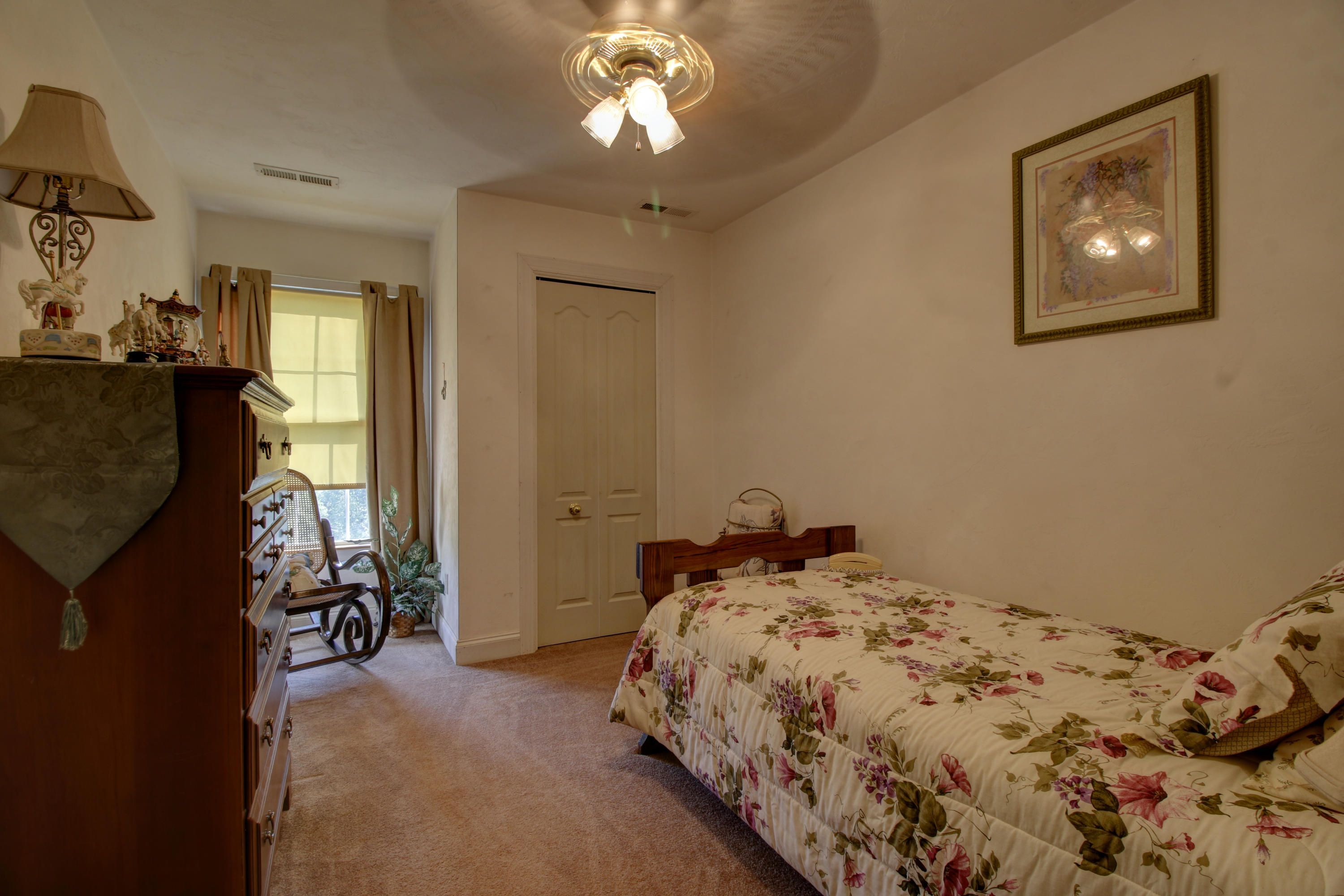 4020 Hatchett Road Penhook, VA 24137 - Photo 30 of 64 a bedroom with a bed and a chandelier