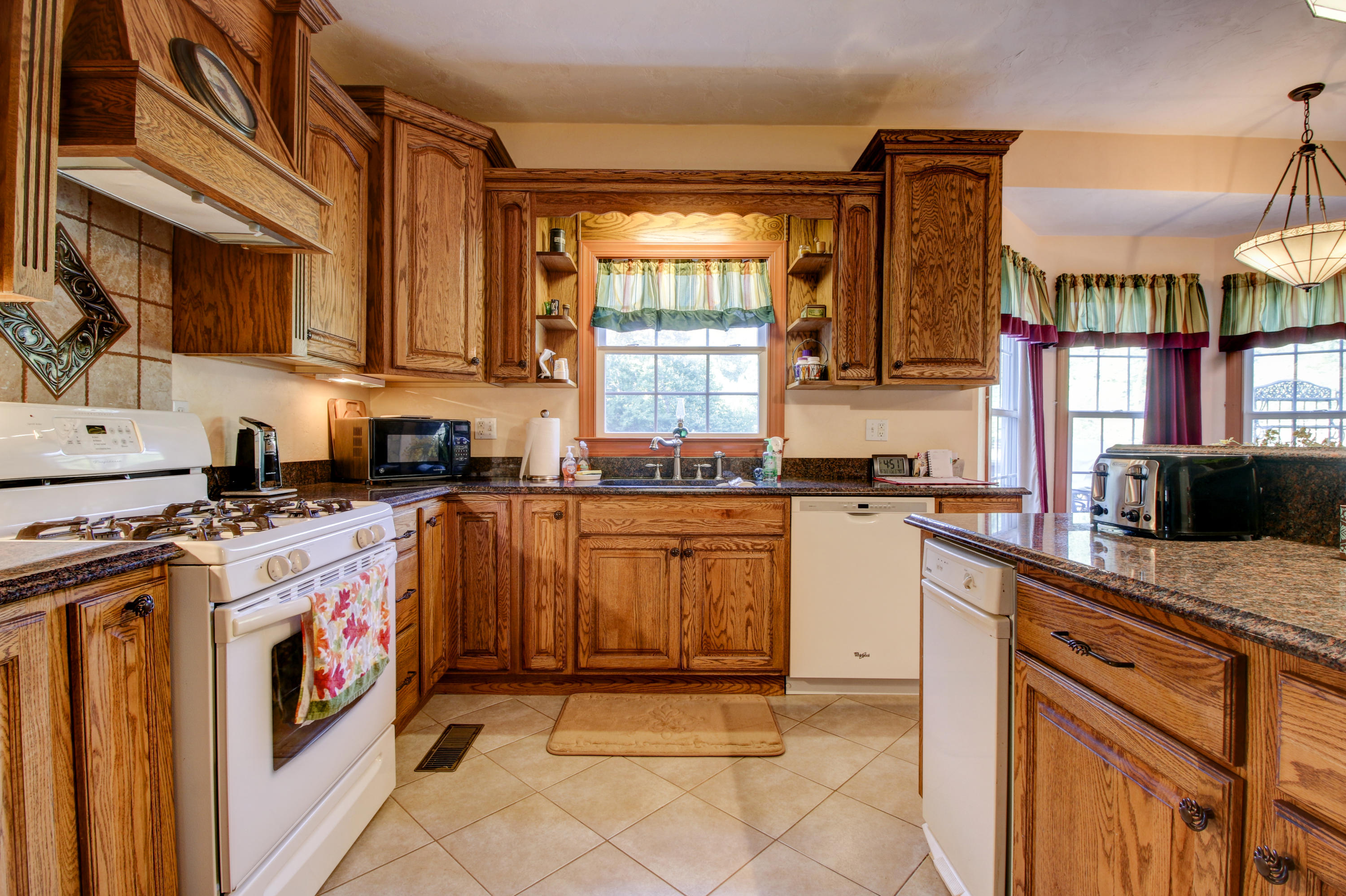 4020 Hatchett Road Penhook, VA 24137 - Photo 10 of 64 a kitchen with stainless steel appliances granite countertop a stove a sink and a microwave