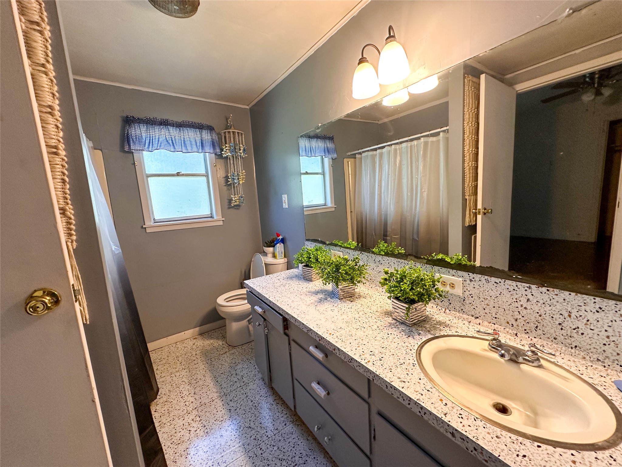 407 4th Avenue Smithville, TX 78957 - Photo 32 of 37 a bathroom with a granite countertop sink and a mirror