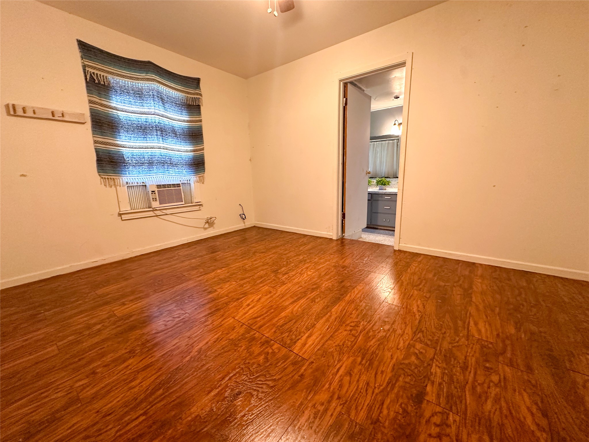 407 4th Avenue Smithville, TX 78957 - Photo 33 of 37 an empty room with wooden floor and windows