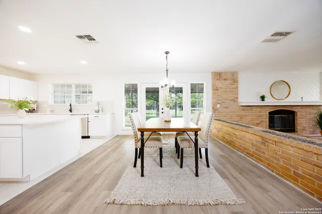 a living room with furniture a fireplace and a table