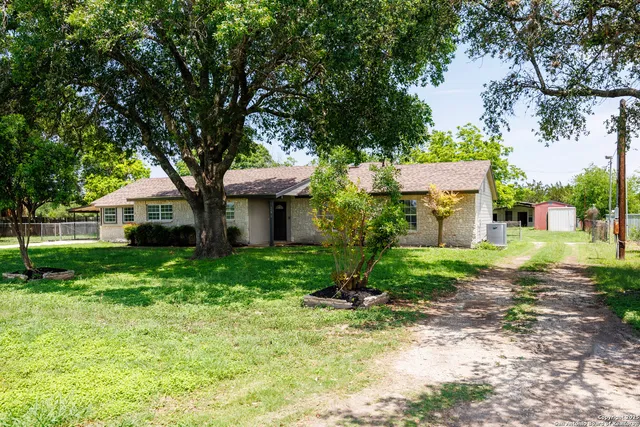 a view of a house with a yard and tree s