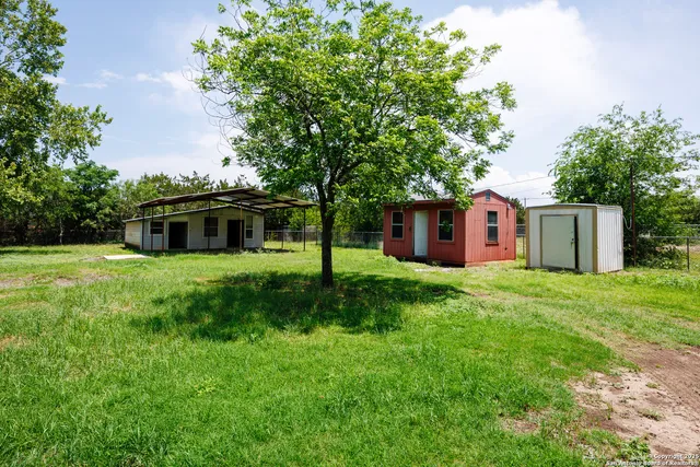 a front view of a house with a garden and yard