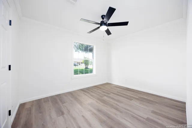 a view of a big room with wooden floor closet and windows