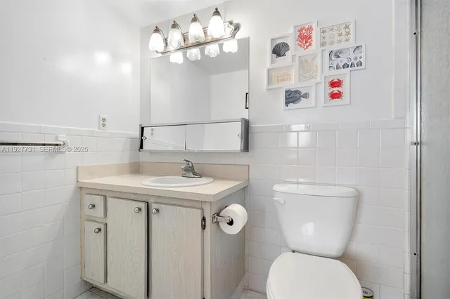 a bathroom with a toilet a sink and a mirror