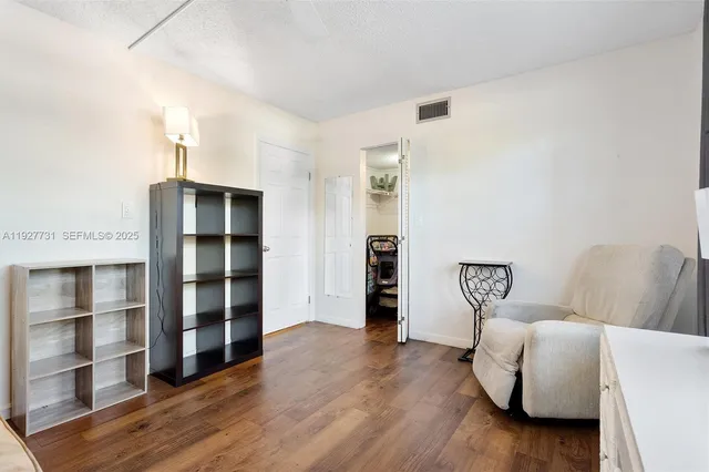 a living room with furniture and a book shelf