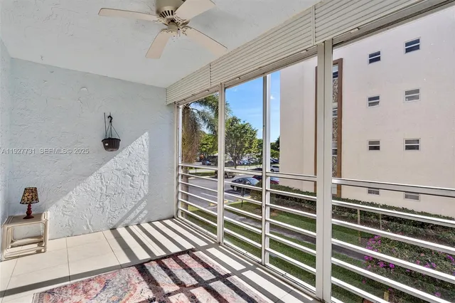 a view of a bedroom with wooden floor and windows