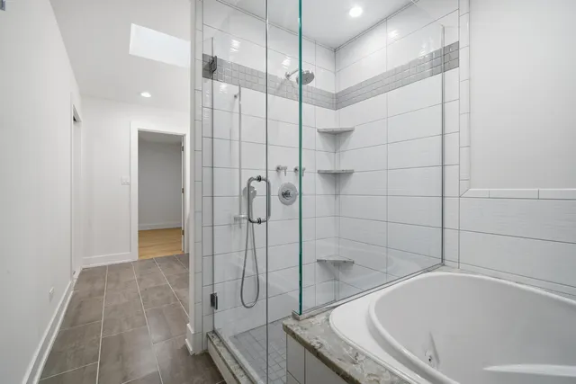 a bathroom with a bathtub and a shower