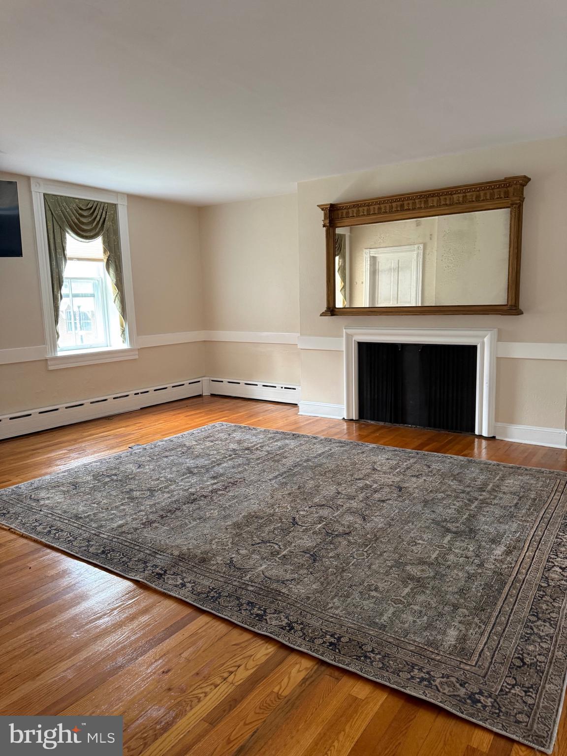 1 Center Street, Unit MAIN Port Deposit, MD 21904 - Photo 5 of 14 a view of empty room with wooden floor and fireplace