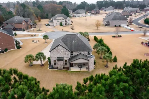 an aerial view of a house with yard swimming pool and outdoor seating