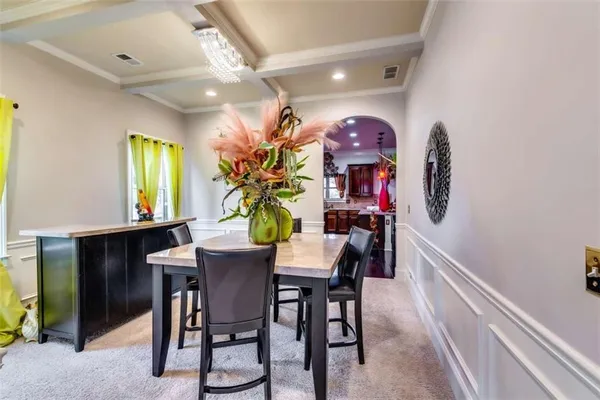 a view of a dining room with furniture and chandelier