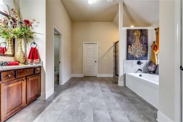 a view of bathroom with bathtub and shower