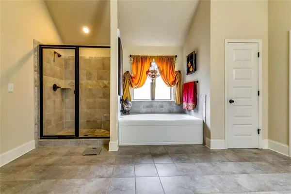 a view of a bathroom with a tub shower and mirror