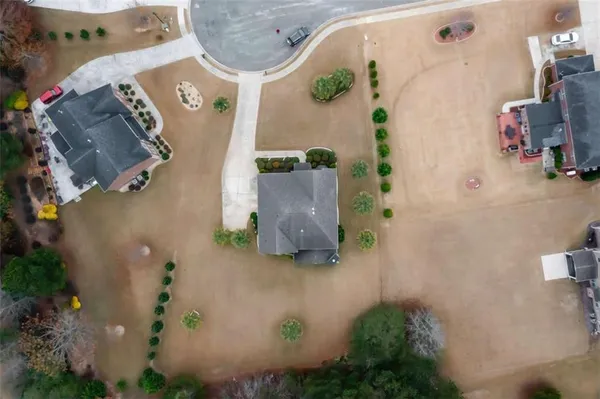 an aerial view of a house with a yard and a wooden floor