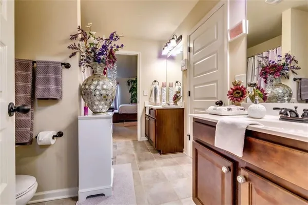 a bathroom with a sink vanity mirror and toilet