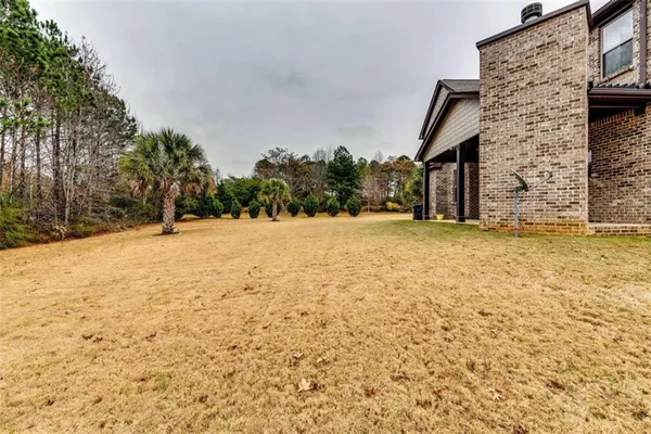 a view of wooden house with a yard