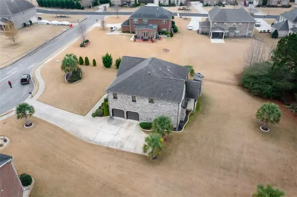 an aerial view of a house with outdoor space and lake view