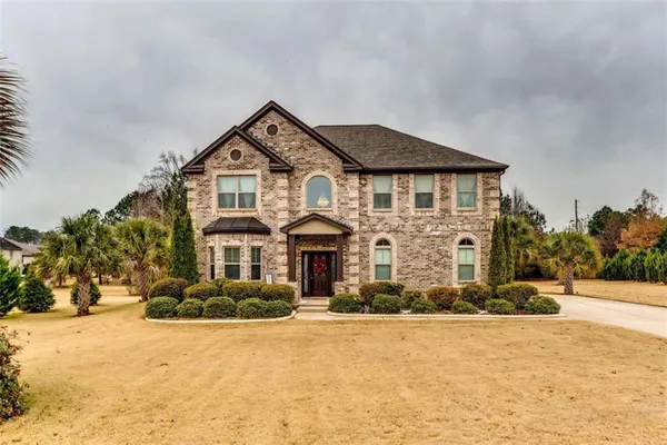 a front view of a house with a yard