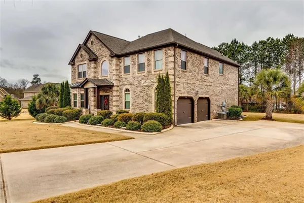a front view of a house with a yard and garage