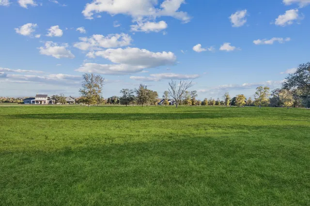 a view of outdoor space with green field and trees
