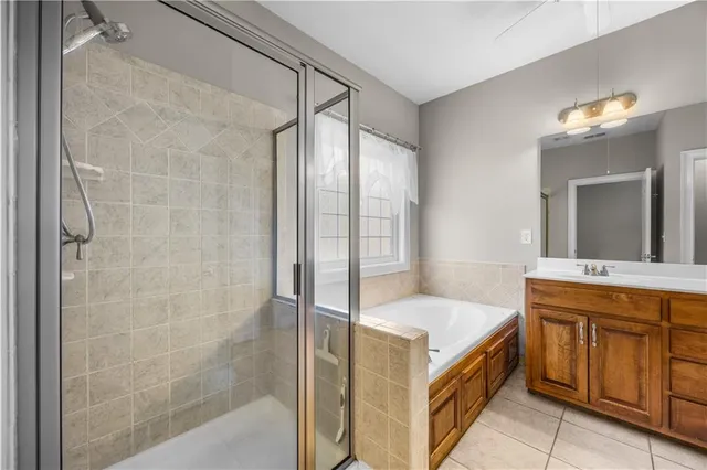 a bathroom with a tub sink and mirror