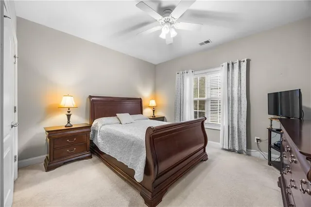 a bed room with a bed and a chair