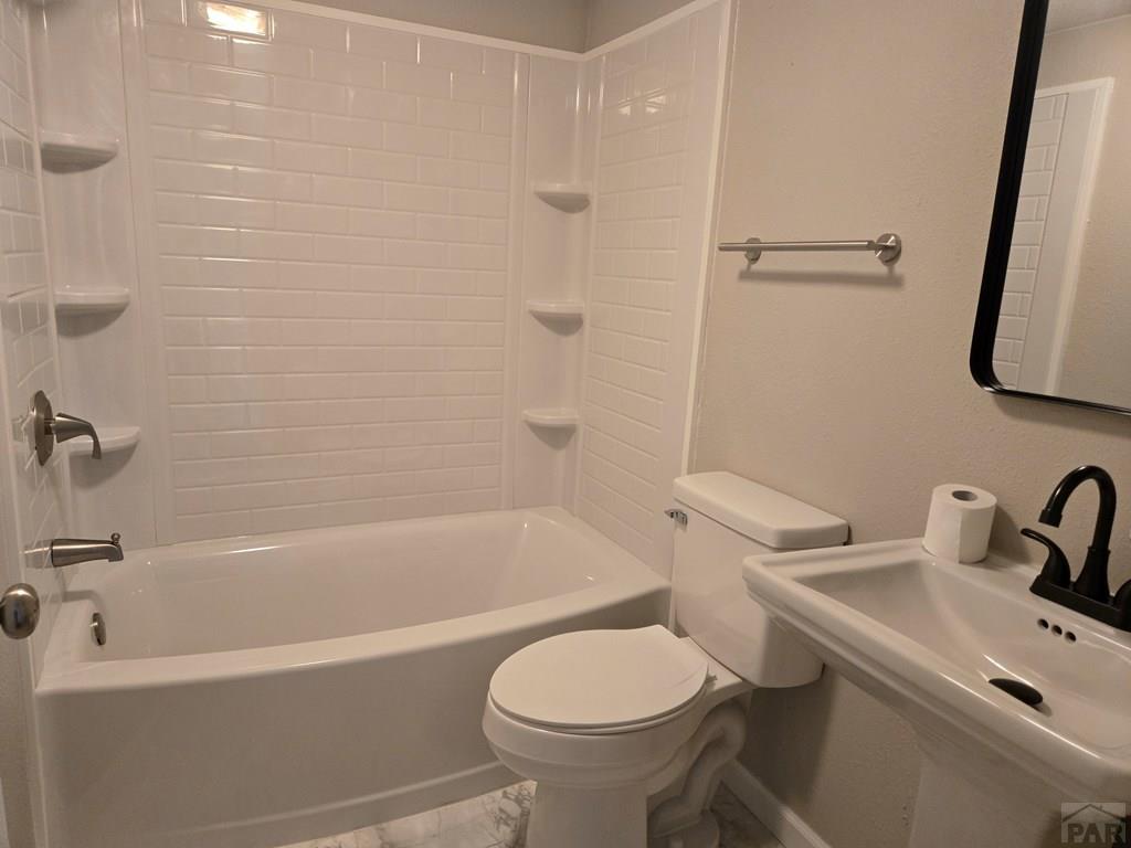8229 Green Lane Rye, CO 81069 - Photo 15 of 24 a white bath tub sitting next to a white toilet and sink