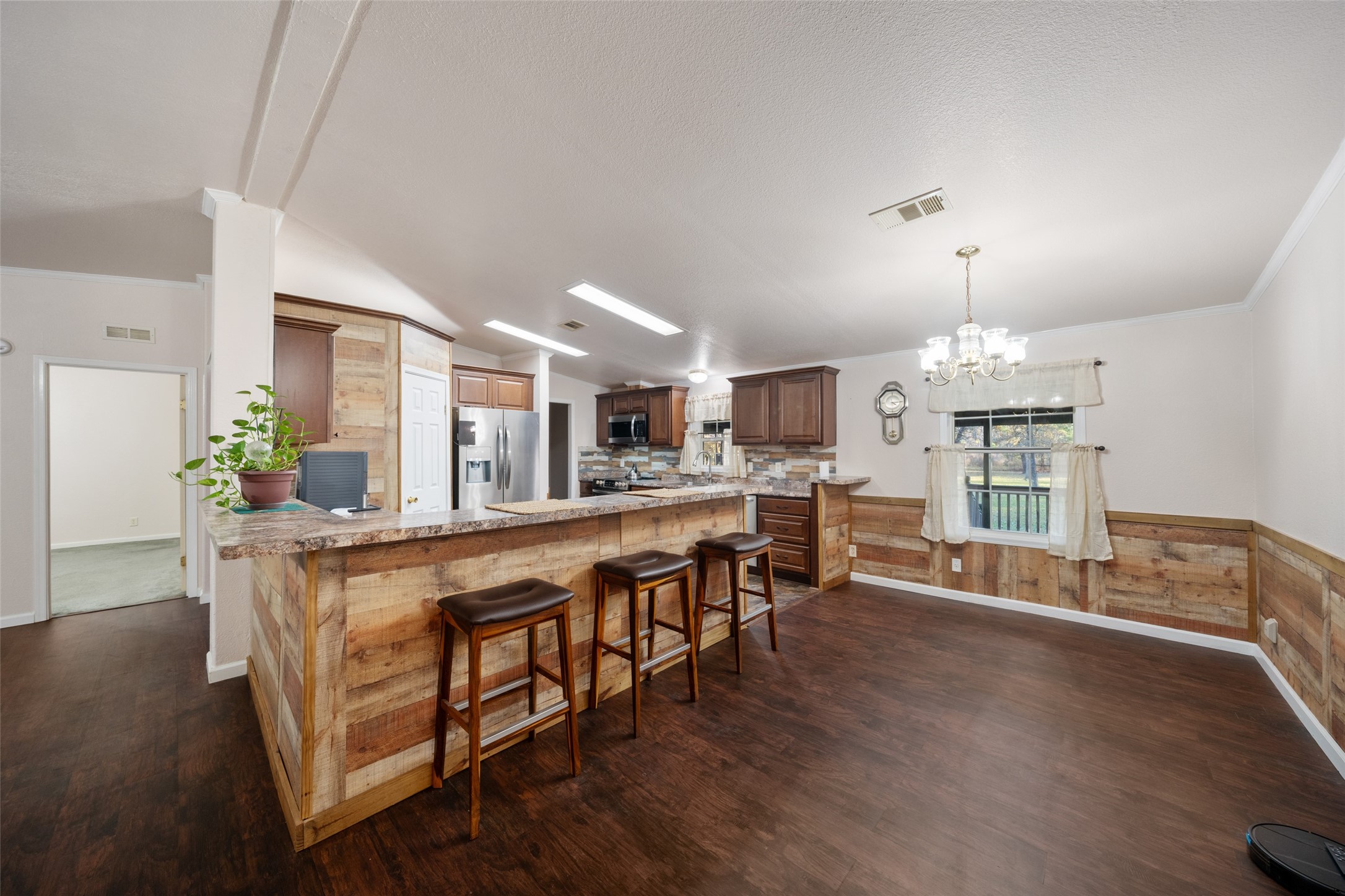 31351 Buckeye Road Waller, TX 77484 - Photo 14 of 36 a large white kitchen with lots of counter space and chandelier