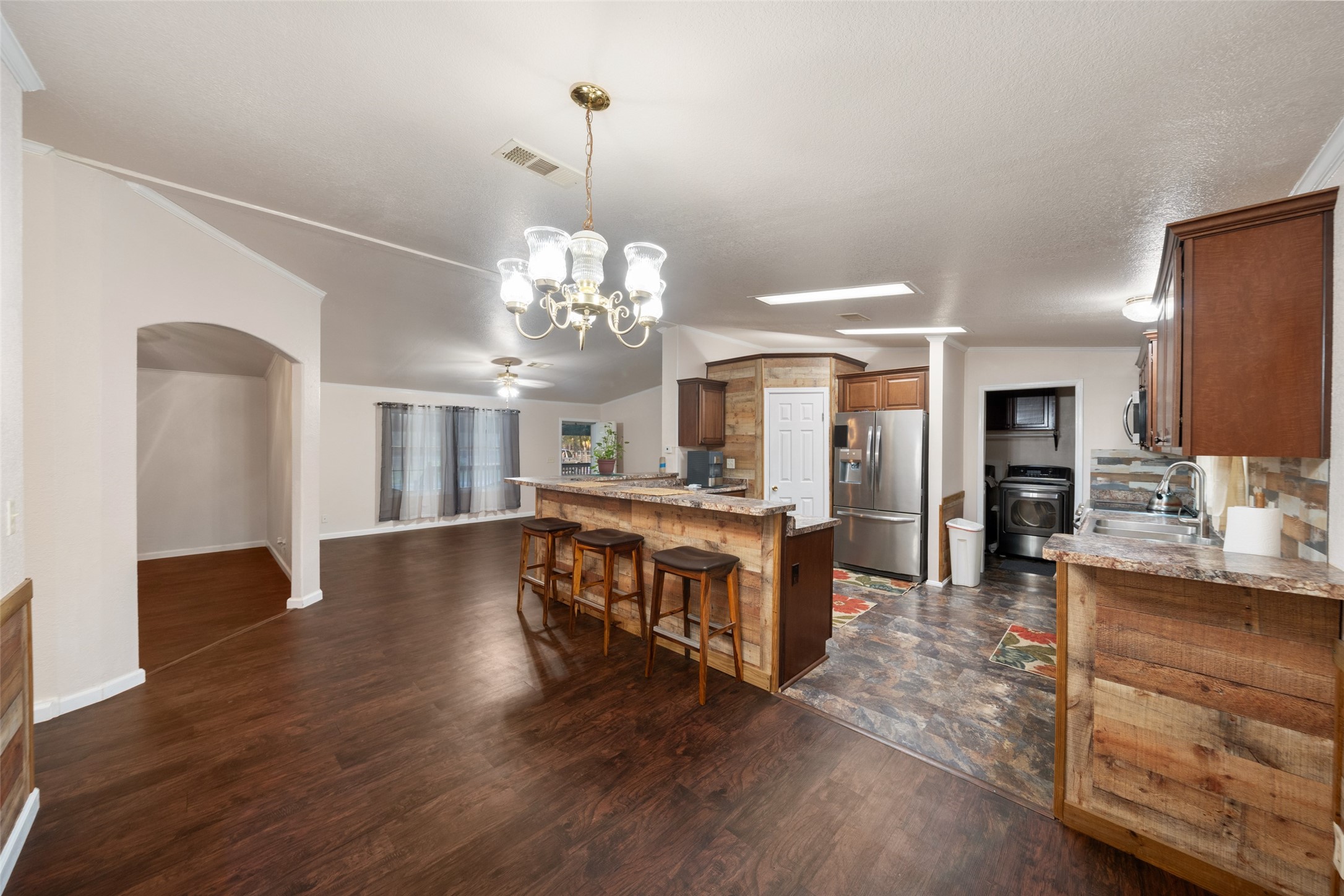 31351 Buckeye Road Waller, TX 77484 - Photo 15 of 36 a view of a dining room with furniture a chandelier and wooden floor