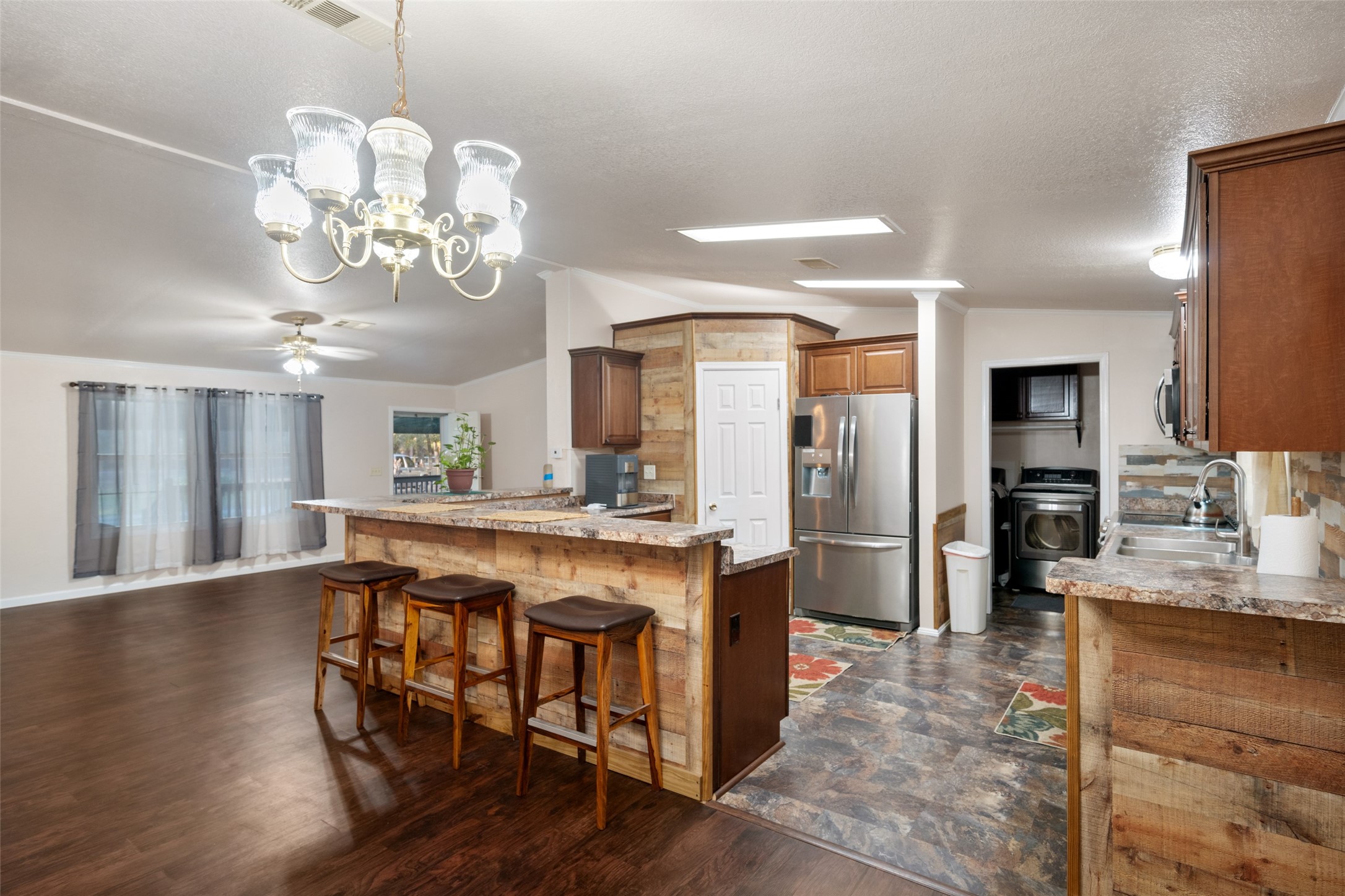 31351 Buckeye Road Waller, TX 77484 - Photo 19 of 36 a view of a dining room with furniture a chandelier and wooden floor